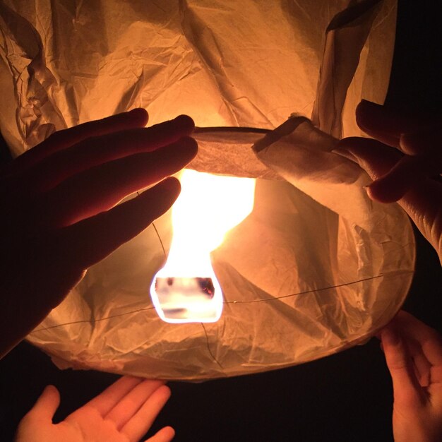 Close-up of hand holding illuminated lamp