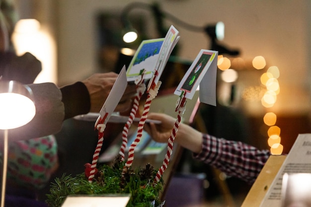 Photo close-up of hand holding illuminated lighting equipment on table