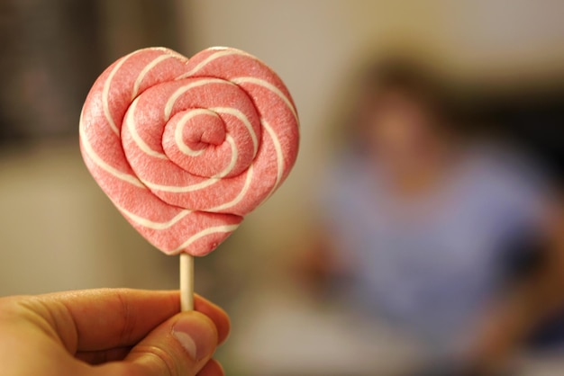 Close-up of hand holding lollipop