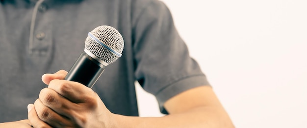 Close up hand holding microphone