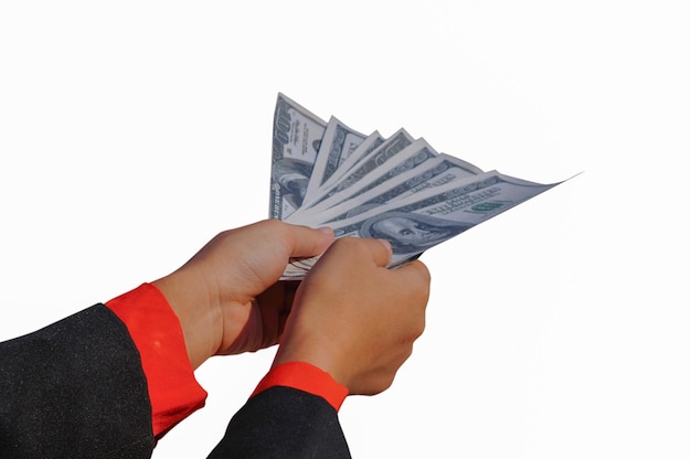 Photo close-up of hand holding paper currency over white background