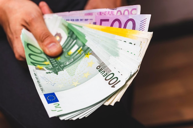 Close-up of hand holding paper currency