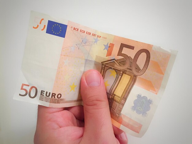 close-up of hand holding paper currency