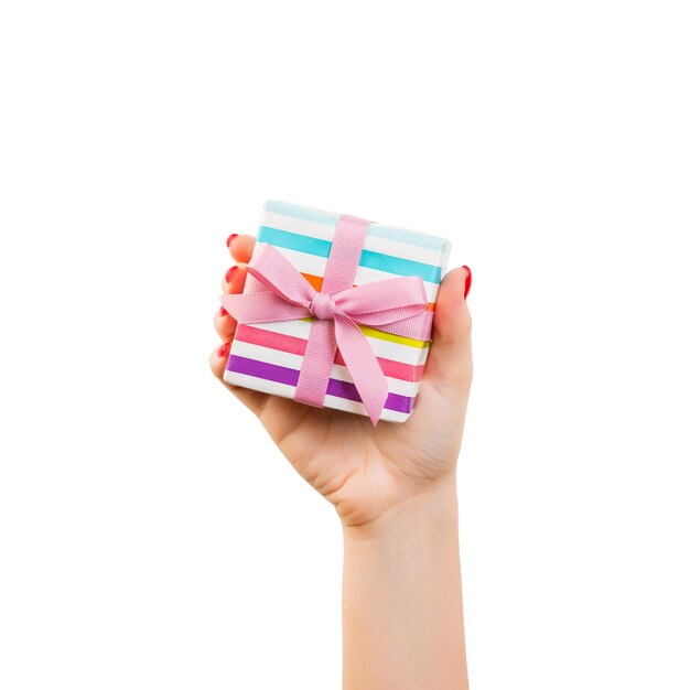 Photo close-up of hand holding paper over white background