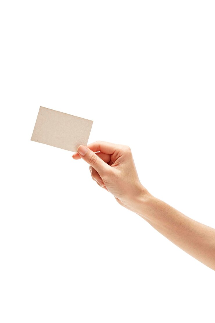 Photo close-up of hand holding paper over white background