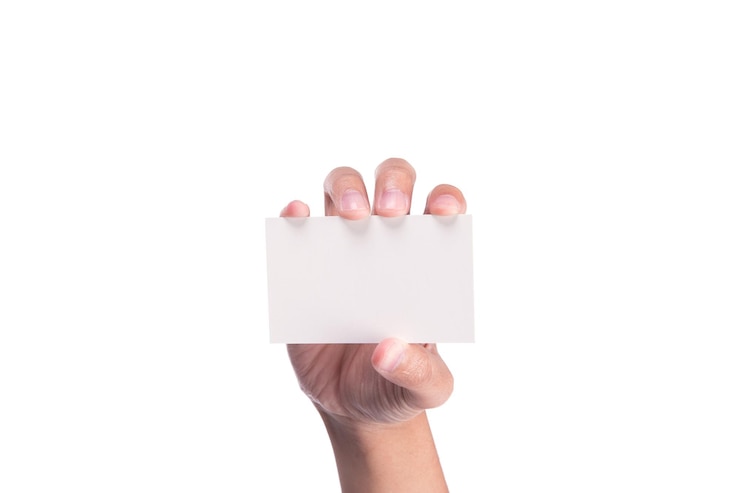 Photo close-up of hand holding paper over white background
