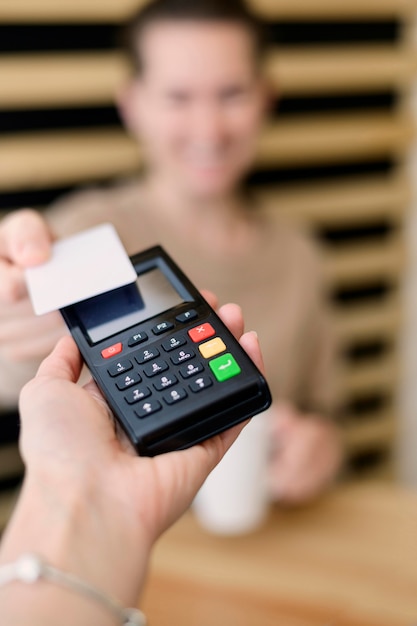 Photo close-up hand holding payment terminal