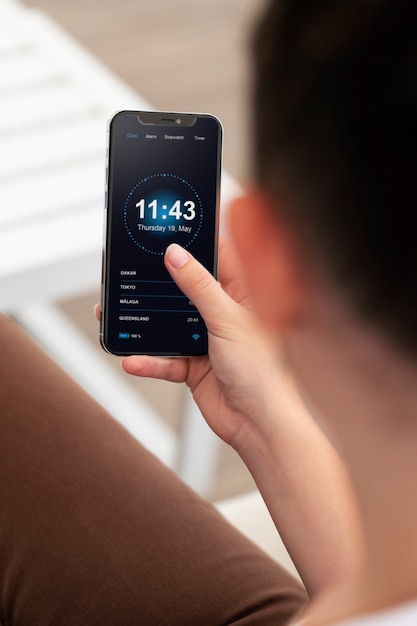 close up hand holding phone with app