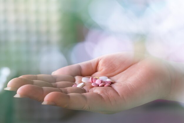 Close-up of hand holding pills