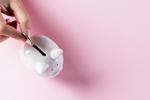 Close-up of hand holding pink over white background