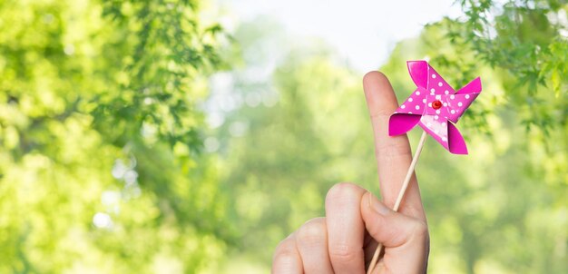 Photo close up of hand holding pinwheel toy