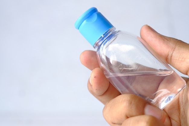 Close up of hand holding sanitizer gel with copy space .