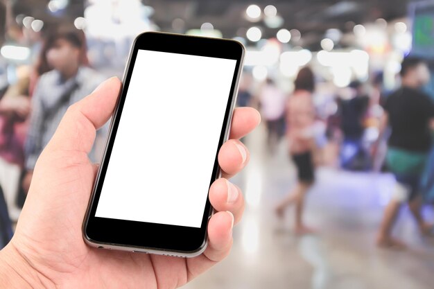 Photo close-up of hand holding smart phone in store