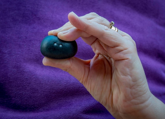 Close-up of hand holding a squash ball