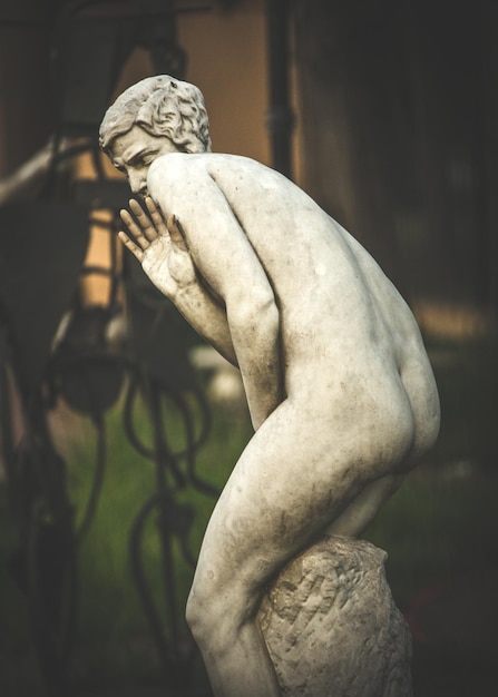 Foto close-up di una statua che tiene la mano contro uno sfondo sfocato