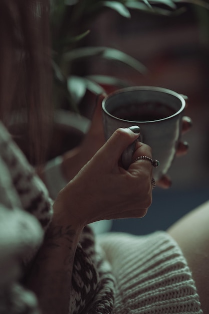 Close-up of hand holding tea cup