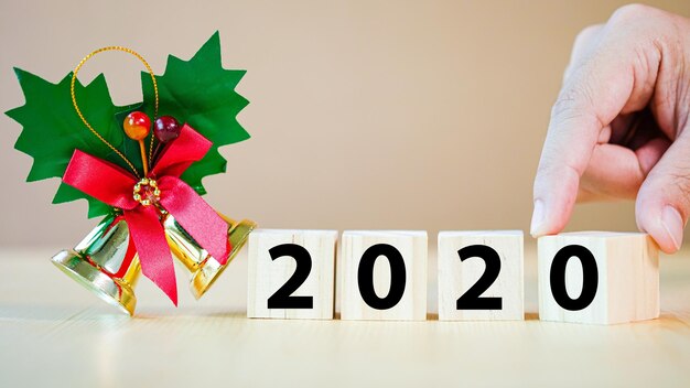 Photo close-up of hand holding toy blocks with numbers