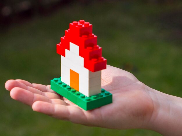 Photo close-up of hand holding toy outdoors