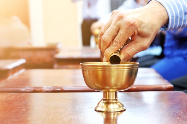 Photo close-up of hand holding wineglass on table