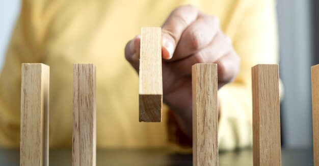 Close-up of hand holding wooden table