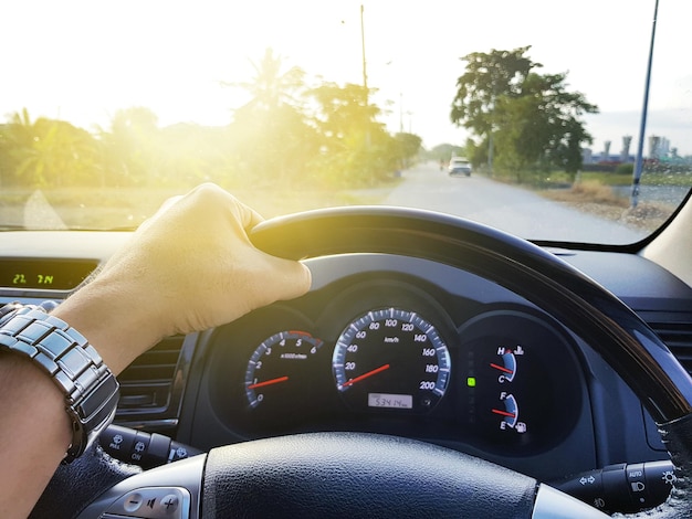 Close-up of hand man driving car