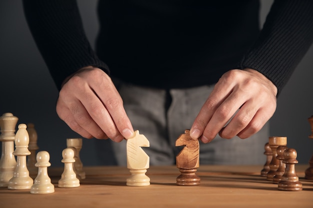 Close up hand of man hold the chess piece