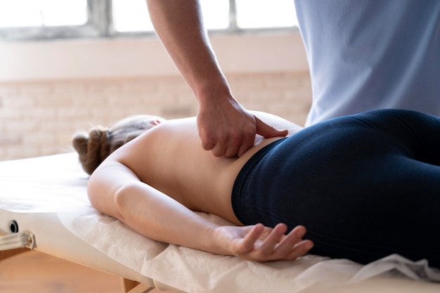 Close up hand massaging lower back