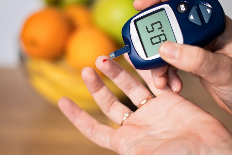 Close up of hand metering glucose in blood at home