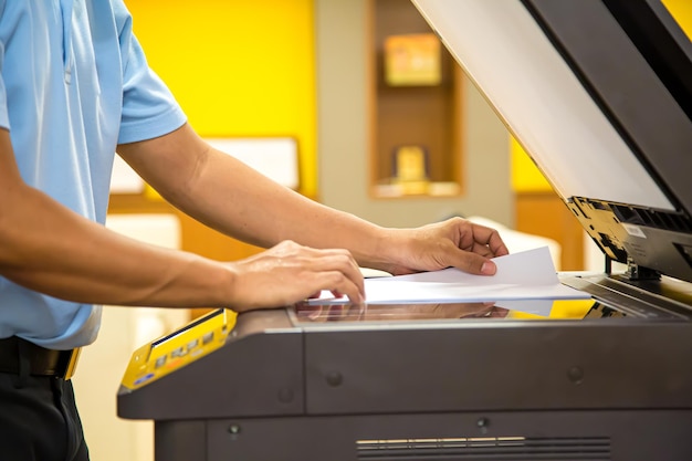 Close up hand office man put paper on panel the copier.