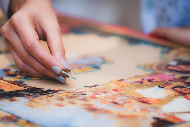 Close-up of hand painting on table