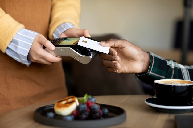 close up hand paying with credit card