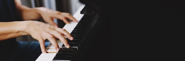 Close up of hand people man musician playing piano keyboard with selective focus keys can be used as a backgroundx9