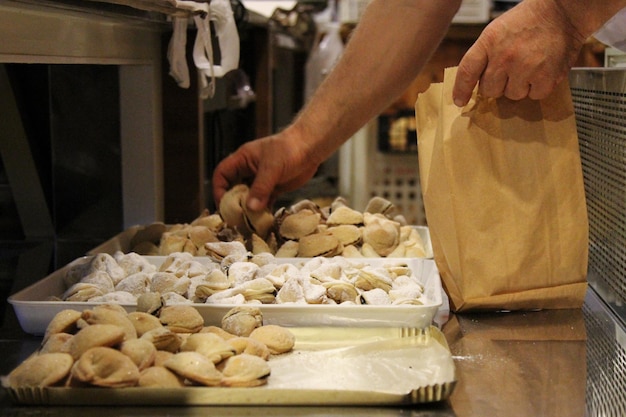 close-up of hand picking pastries