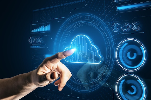 Close up of hand pointing at glowing cloud computing hologram on dark background Database concept