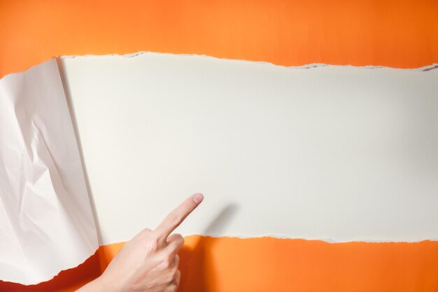 Photo close-up of hand pointing on paper