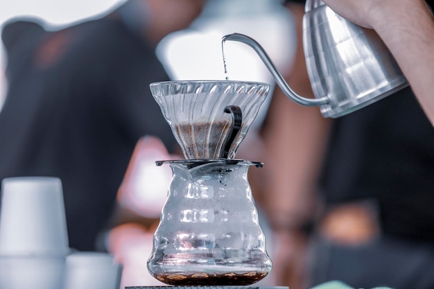 Photo close-up of hand pouring coffee cup