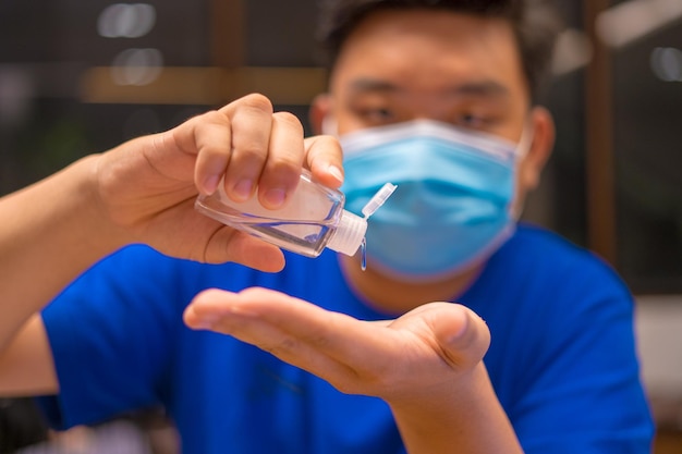 Close up hand sanitizer man applying sanitizing gel liquid rubbing hands clean personal hygiene