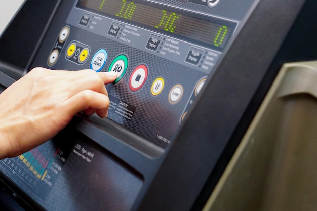 Close up of hand selecting a function from the treadmill