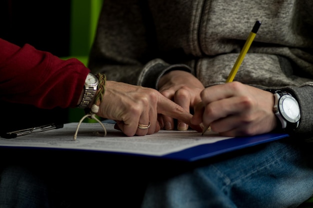 Close-up of hand signing document