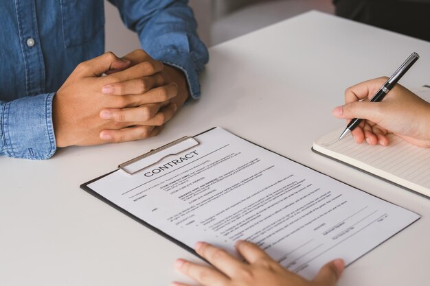 Close up hand of tenant client sign signature contract rental purchase buyer home or apartment with landlord realtor after banker agreement mortgage loan success or done Property agent concept