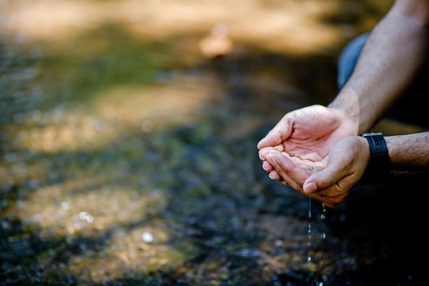 Close-up of hand touching water