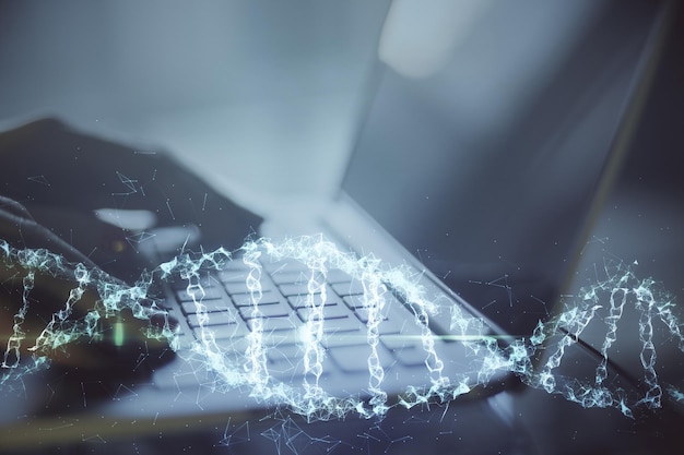 Close up of hand typing on keyboard laptop with digital dna spiral hologram