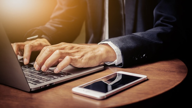 Close up hand using computer, Businessman typing laptop