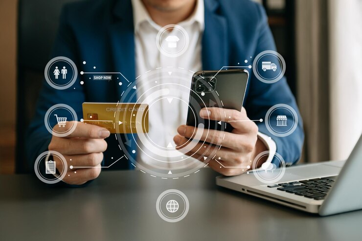 Photo close up of hand using credit card and smartphone laptop computer on wooden desk with vr icon chart graph diagramxa
