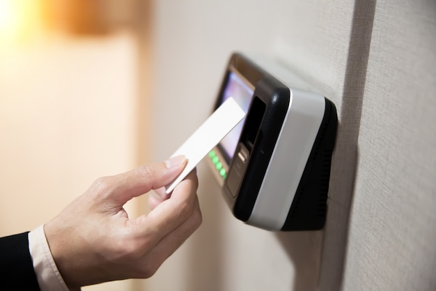 Close-up of hand using keycard to open the door.