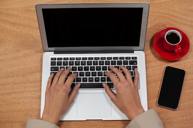 Close-up of hand using laptop