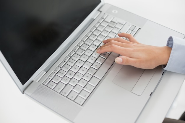 Close up of a hand using laptop