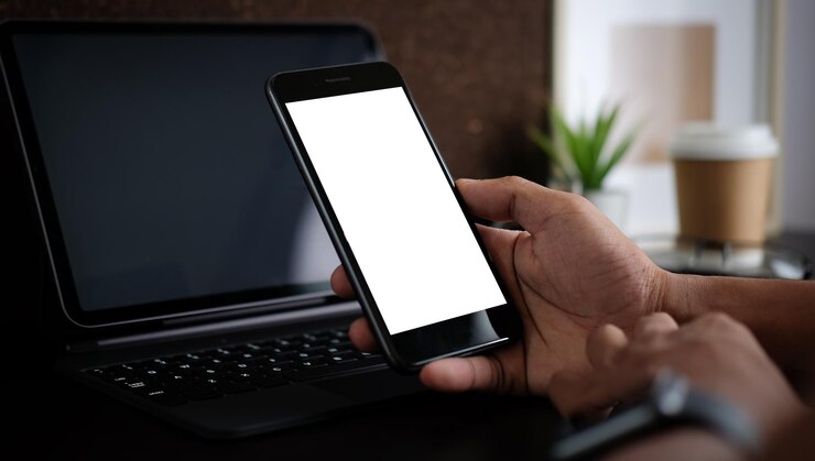 Photo 携帯電話で手のクローズアップ