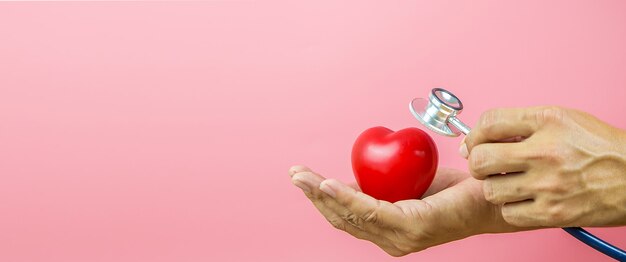 Close-up hand using a stethoscope to check the heart