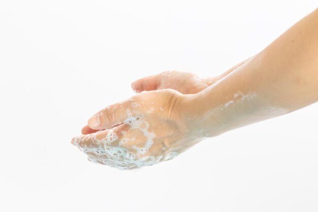 Photo close-up of hand over water against white background